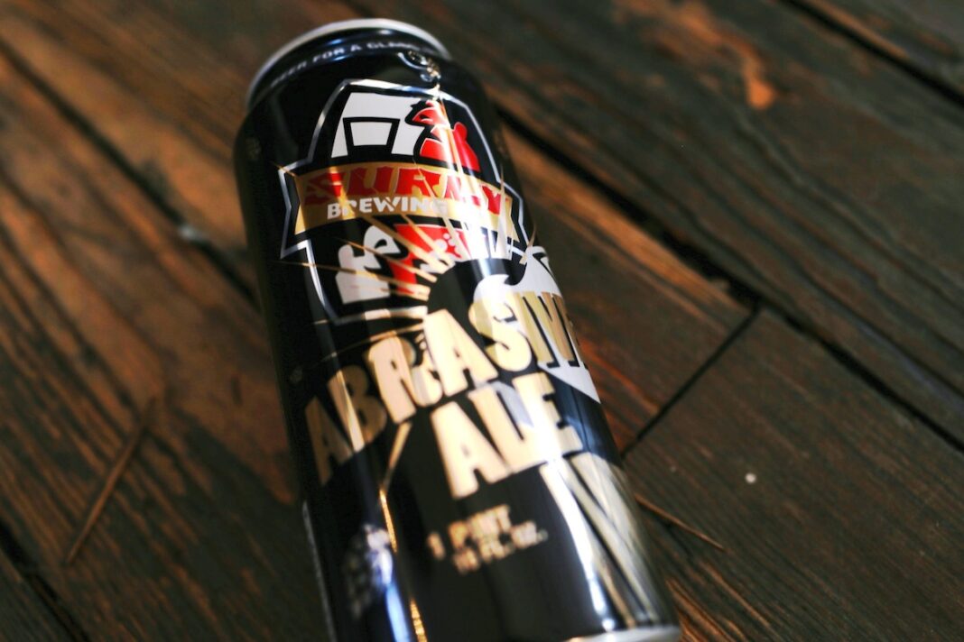 Abrasive Ale Imperial IPA beer bottle with impressive design, standing out against the soft light background.