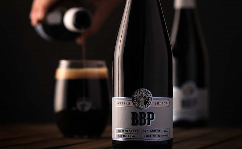 BBP bottle with vintage label, next to a glass of smooth dark beer