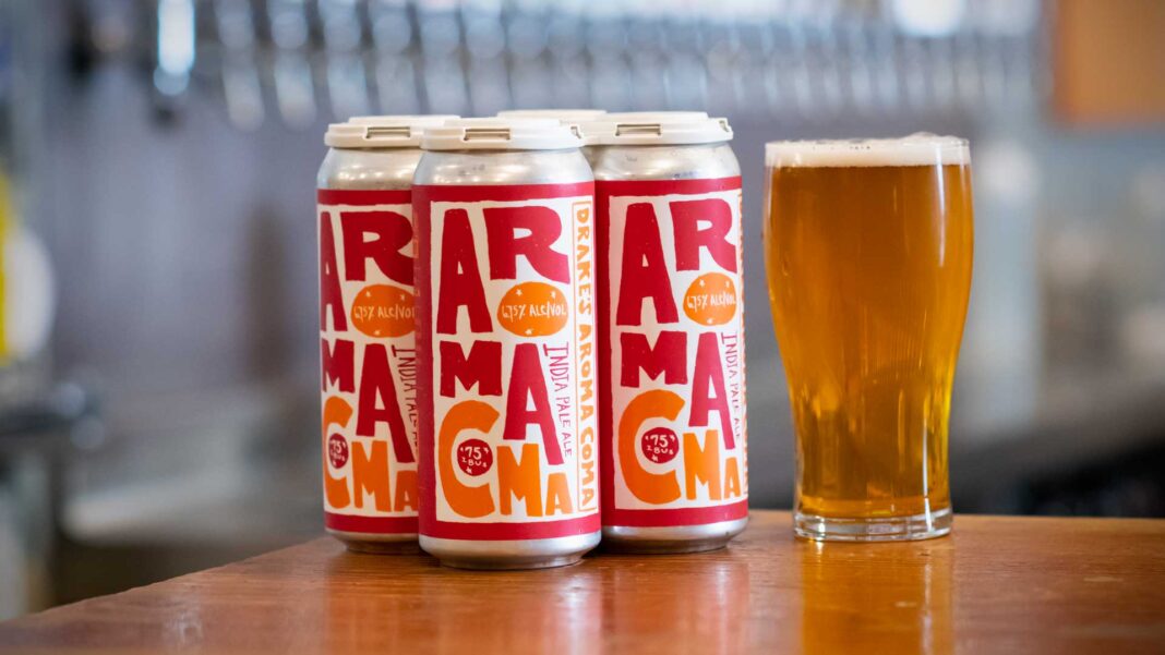 Aroma Coma beer bottle with outstanding red-orange label design, symbol of Western IPA.