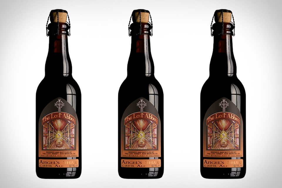 The Angel's Share beer bottle image features a classic black label on a dark wood background.