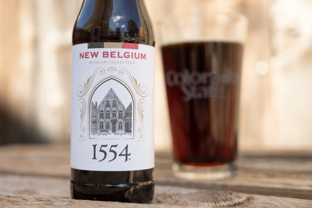 Image of 1554 beer bottle with simple, luxurious design, highlighting the product name and New Belgium Brewing Company logo.