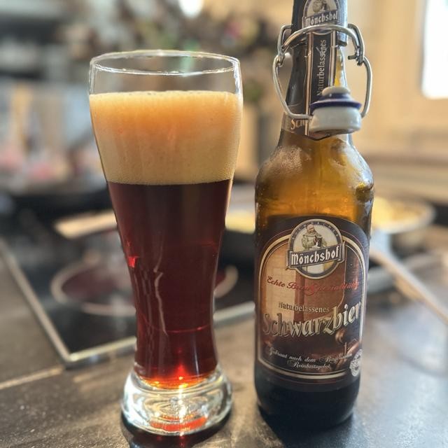 The dark beer turns to a ruby-brown color when lit - Mönchshof Schwarzbier: 220-year-old Masterpiece of Darkness