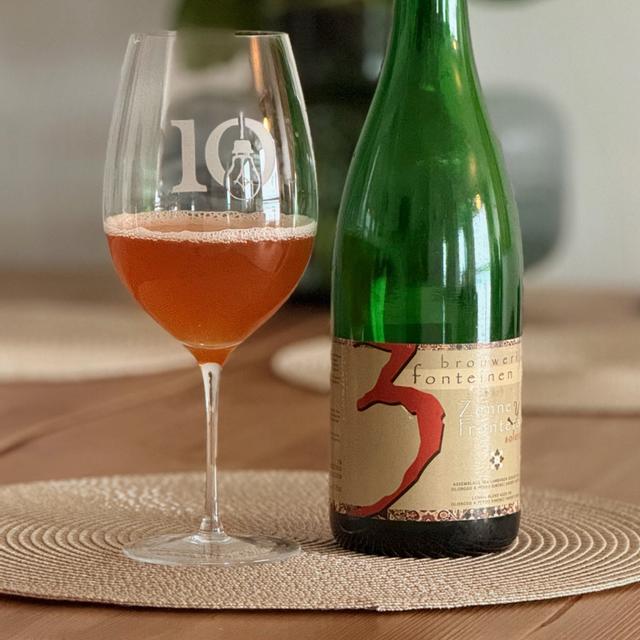 The beer has a ruby red color that shimmers behind the glass like a precious gem of the land reflecting the red rays of the sun under the warm golden light - Zenne Y Frontera: The Quintessential Vibrations of Drunkenness