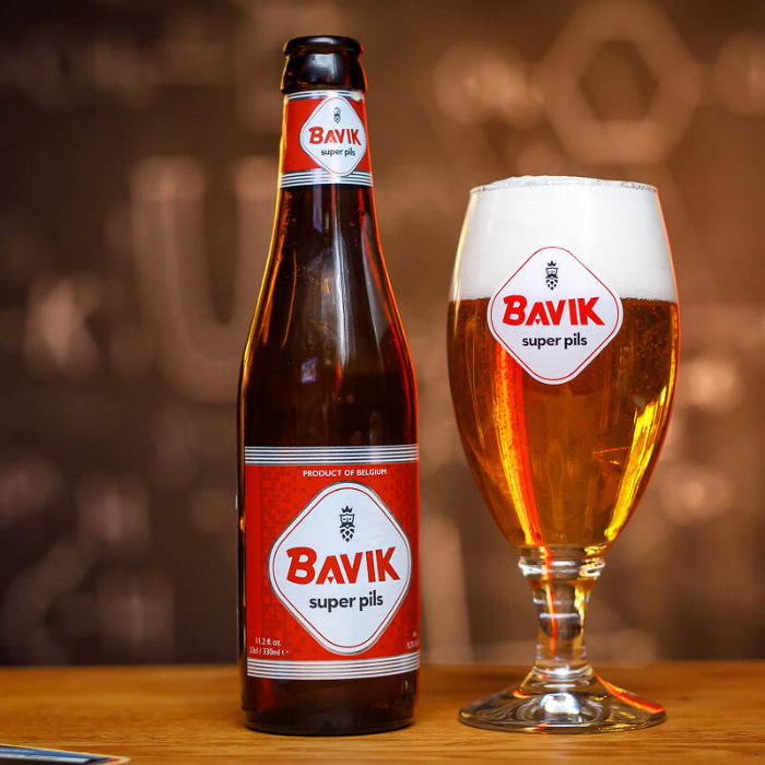 A warm amber-colored beer with a smooth, white powder - Bavik Super Pils: The Gold Standard of Purity
