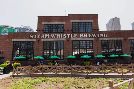 Exterior view of the modern Steam Whistle Brewery Biergarten and Taproom - Steam Whistle Pilsner: The Sound of the Steam Whistle and the Golden Love Song