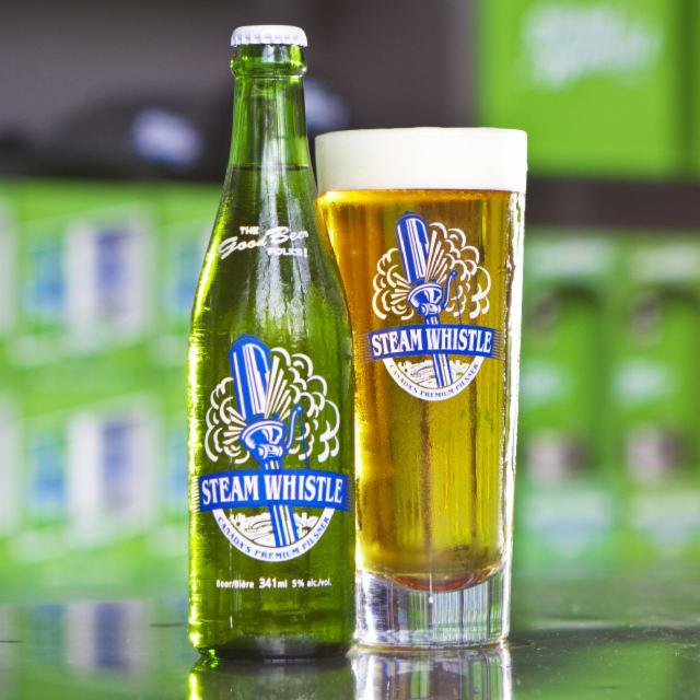 Steam Whistle Pilsner has an impressive green beer bottle design with a central location - Steam Whistle Pilsner: The Sound of the Steam Whistle and the Golden Love Song