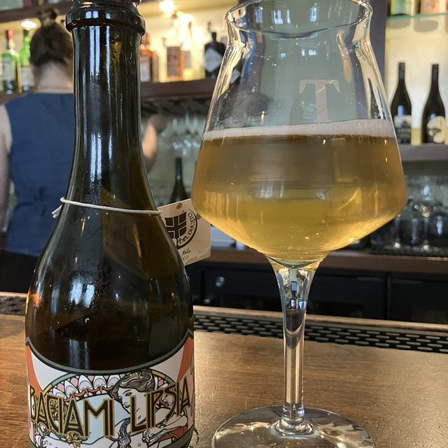 Baciami Lipsia beside a glass of attractive golden beer - Baciami Lipsia: A Wild Kiss Imbued with the Soul of Italy