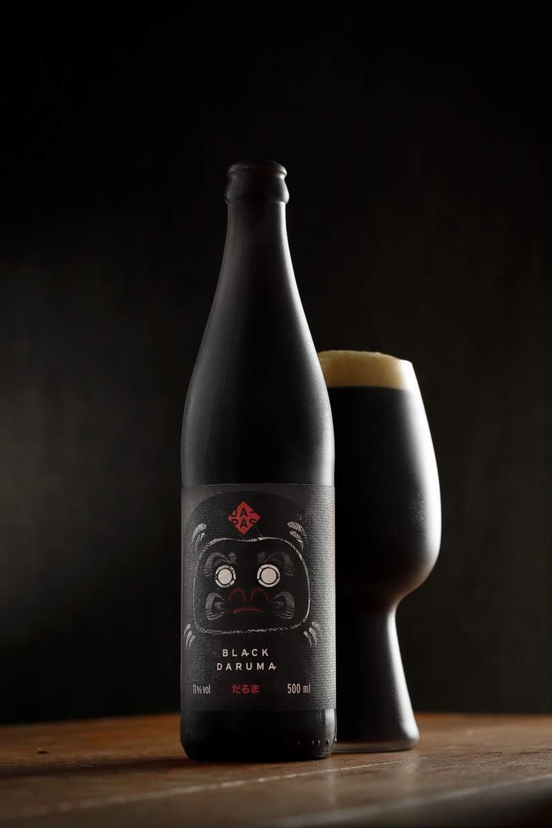 Black Daruma: A Soul Brewed by a Desire Black Daruma has a dark black design with a cute image of a bull - Black Daruma: A Soul Fermented From A Desire