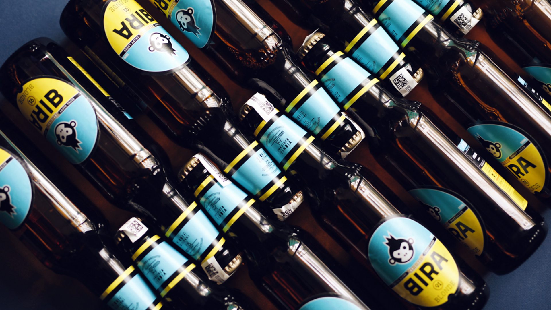 Image of Bira 91 Blonde Lager beer bottles stacked in an interesting way - Bira 91 Blonde: Golden Yeast Awakens All Senses