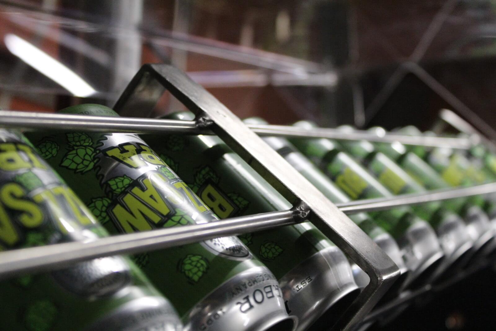 Image of Buzzsaw American IPA beer cans in the beer production line - Buzzsaw American IPA: A Golden Declaration for Taste Revolution