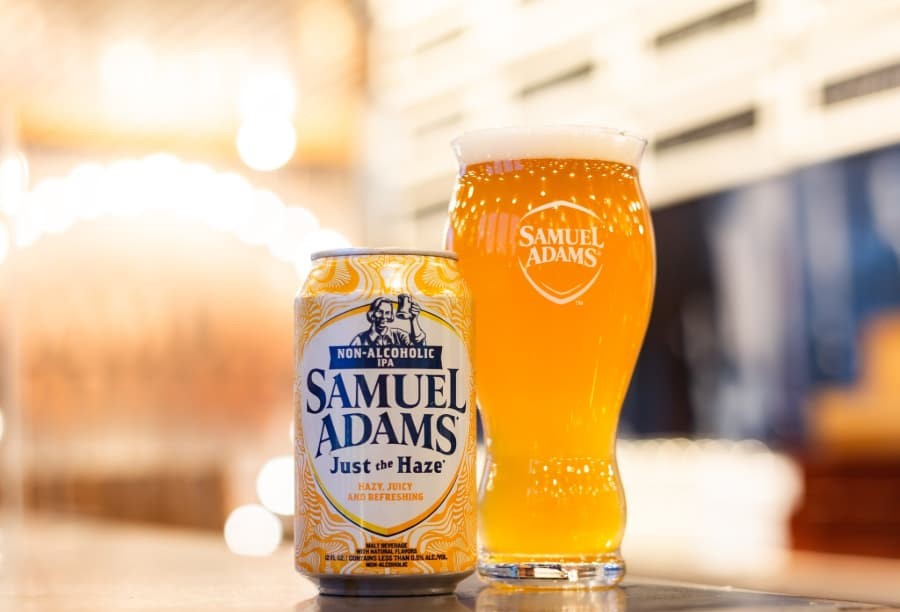 Just The Haze: A Gentle Manifesto of Non-Alcoholic Beer Just The Haze beer glass, attractive golden yellow color with a layer of white powder - Just The Haze: The Gentle Manifesto of Non-Alcoholic Beer