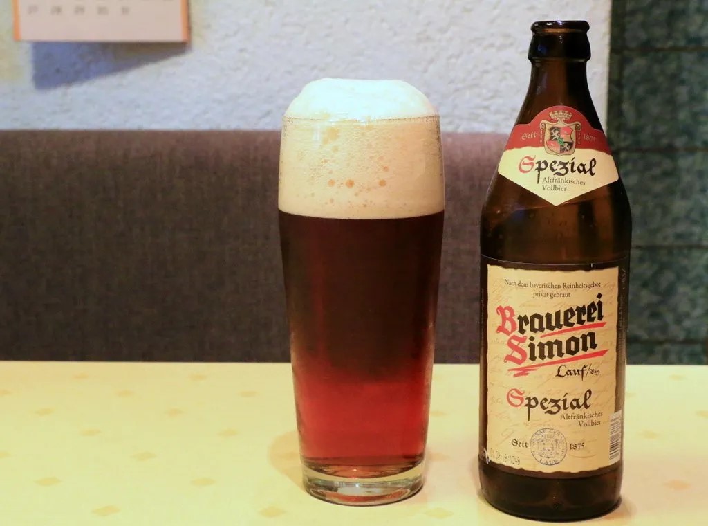 Simon Spezial Altfrankisches Vollbier sits atop a table radiating magical light - Simon Spezial Altfränkisches Vollbier: The Beer of the Century