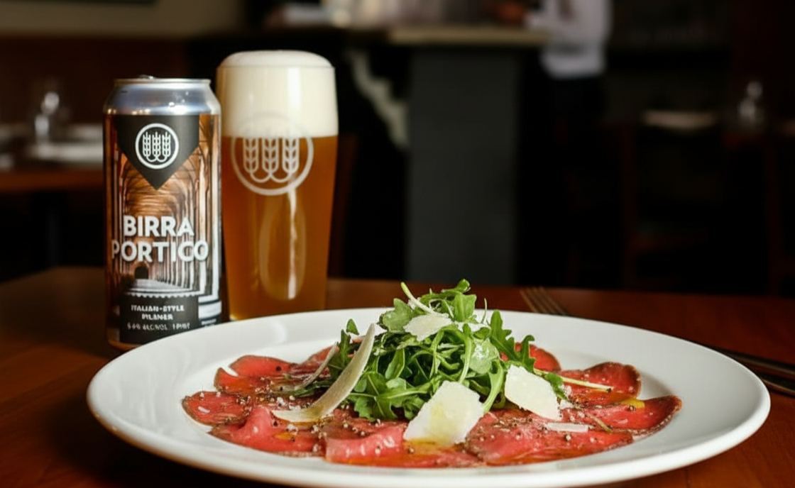 Carpaccio mit seiner zarten, fast ohrenbetäubenden Textur und Birra Portico, ein perfektes Paar raffinierter Aromen – Birra Portico: Eine goldene Symphonie aus Sonnenschein und Blüten