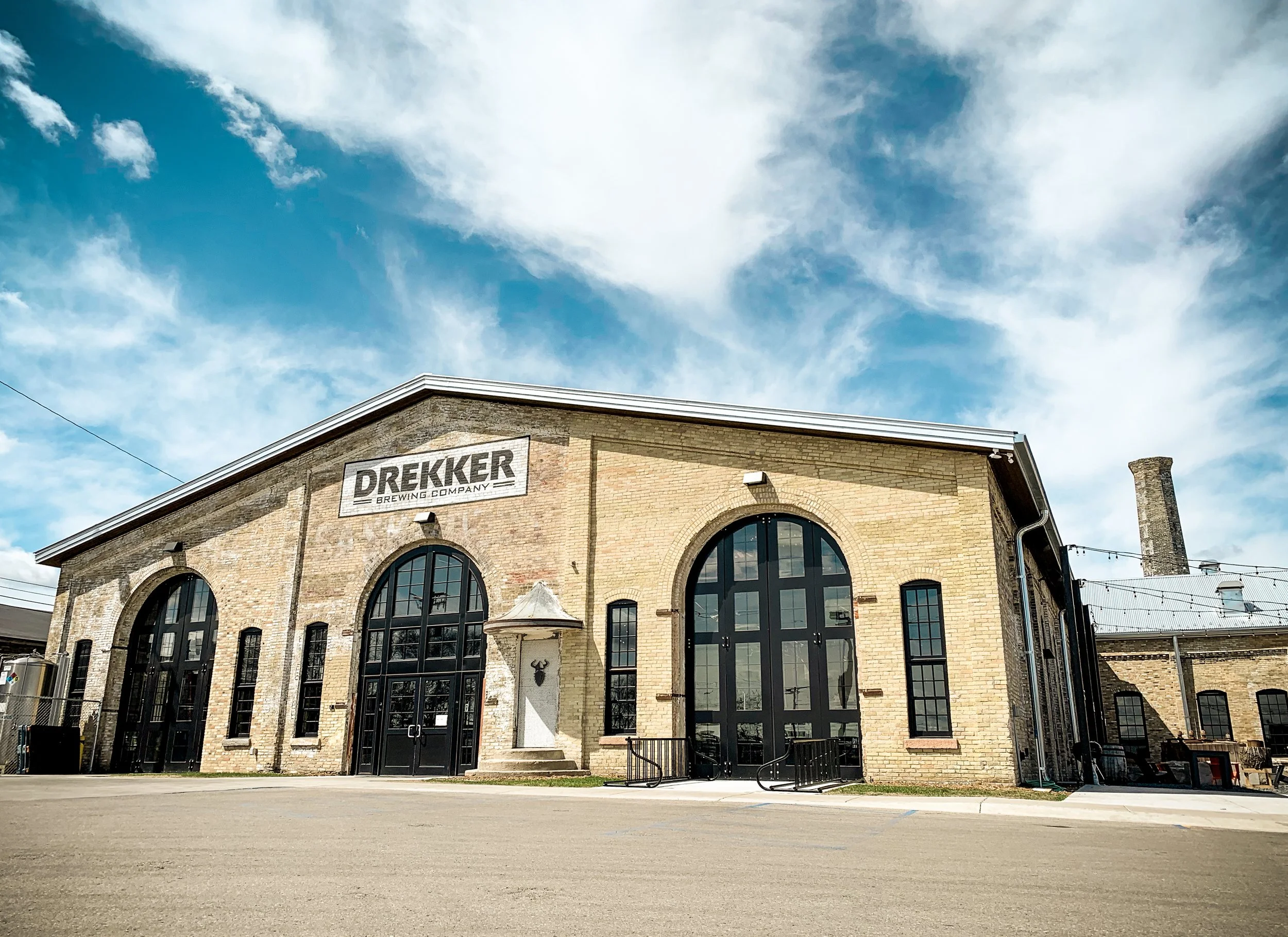 The exterior of the Drekker Brewing Company brewery features modern glass windows - Everybody Love: Love Becomes the Taste of Beer