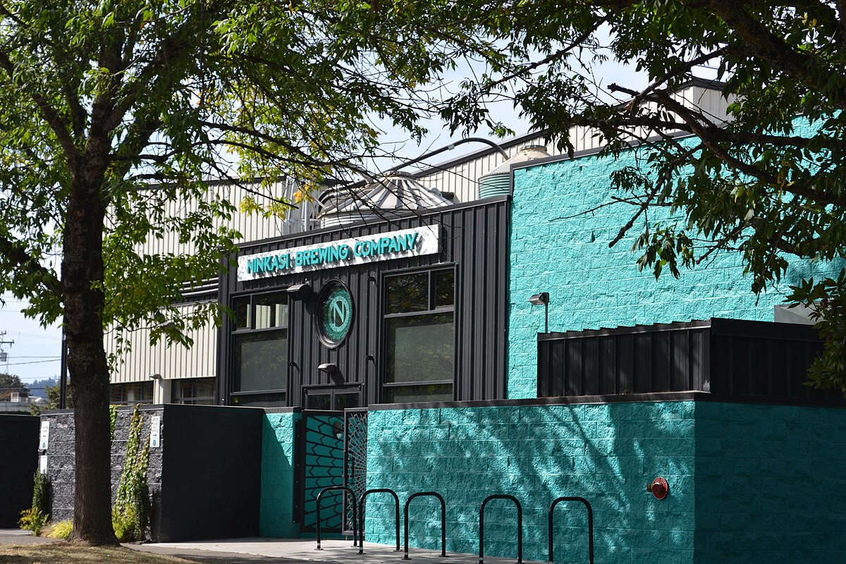 An exterior image of the Ninkasi Brewing Company brewery with its striking blue color - Mastodom Imperial Cold IPA: The Rulers of the Beer World.
