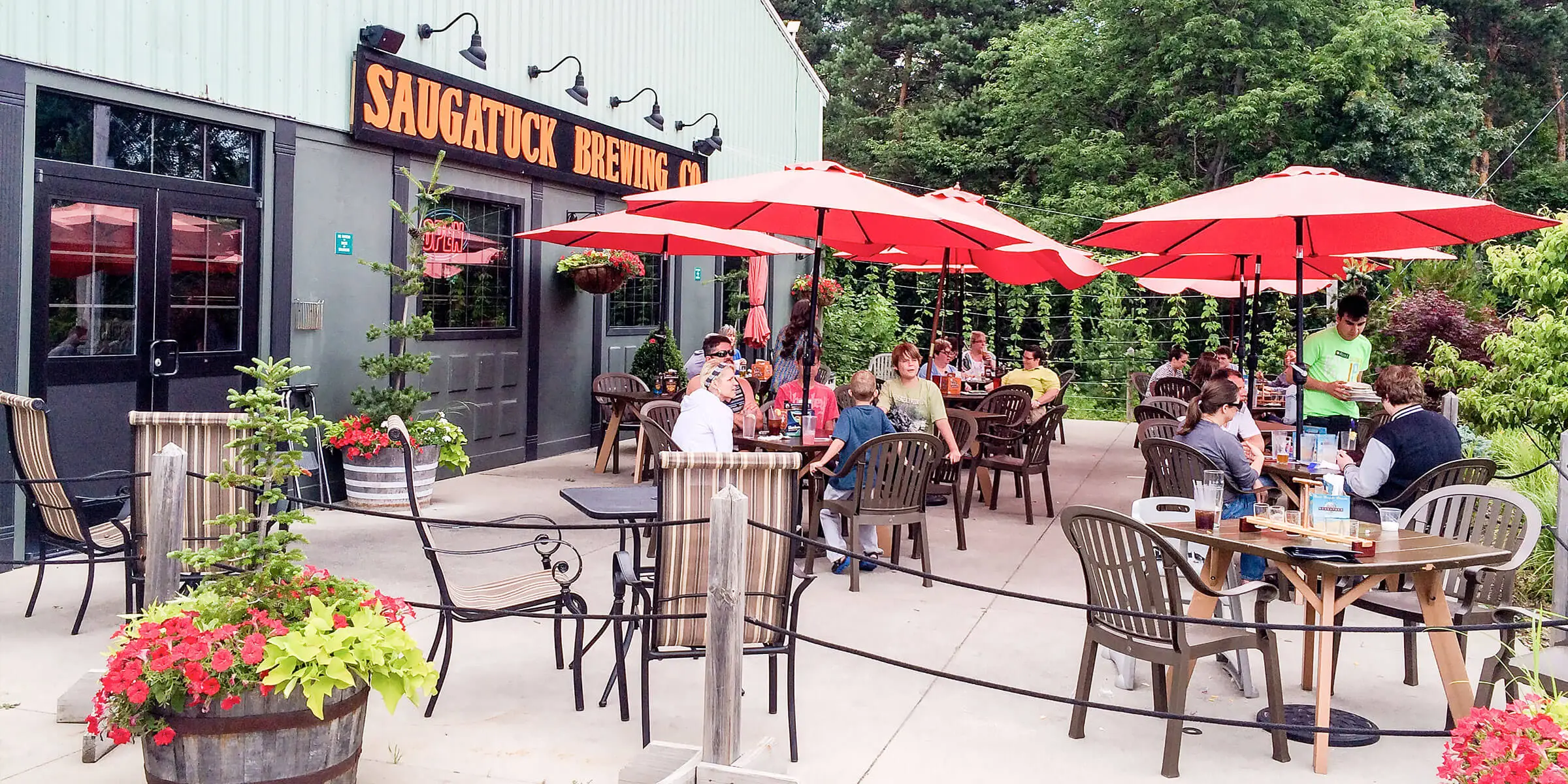 Images of tourists enjoying beer outside the Saugatuck Brewing Company - Neapolitan Milk Stout: A Sweet Love Song from Childhood