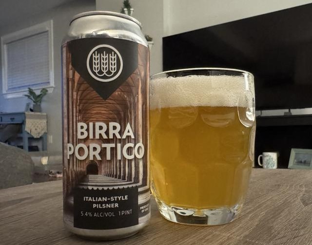 Auf dem großen Bild von Birra Portico ist deutlich der Titel zu sehen: Birra Portico: Eine goldene Symphonie aus Sonnenschein und Blumen.