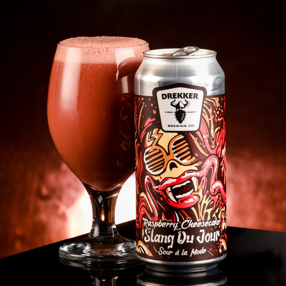 The image shows a glass of beer with a deep ruby red color, like wine - Slang Du Jour - Raspberry Cheesecake: A Flavor for an Adventurous Soul