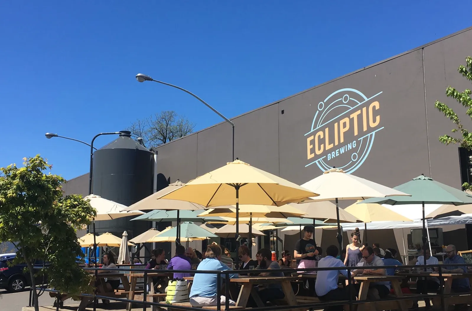 A picture of customers enjoying beer outside the Ecliptic Brewing Brewery - Ecliptic Cold IPA: A Masterpiece Between Two Skies