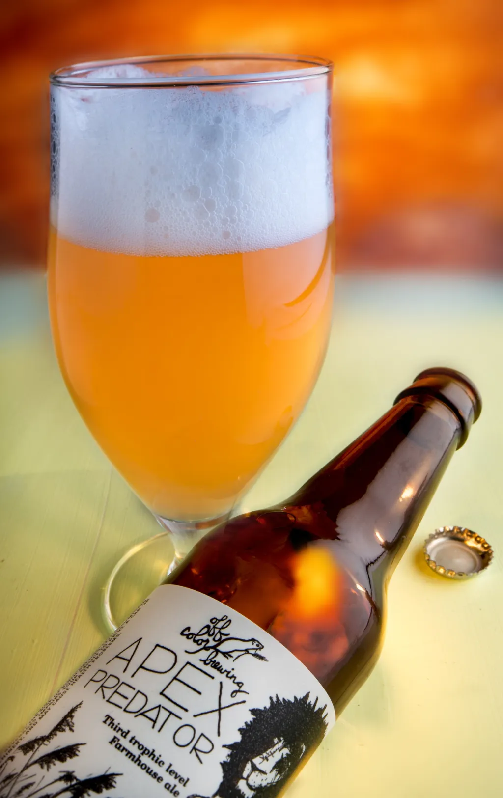 The Apex Predator beer glass has a color ranging from a pale yellow to amber - Apex Predator: The Proud Saison Glass in the World of IPA